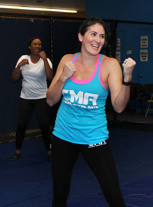 Students at a Women's Self-Defense class practicing boxing