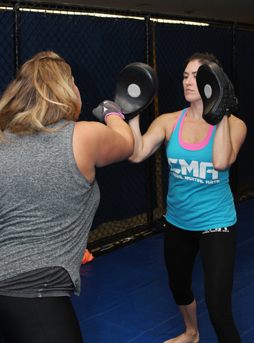 Women's Self-Defense class with students practicing boxing combos