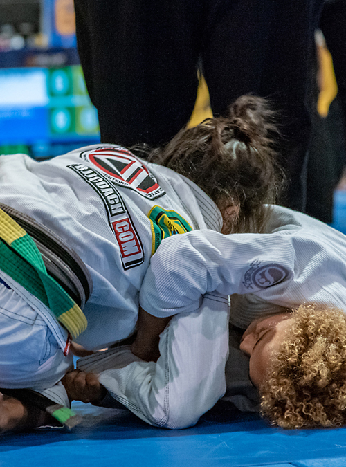 Kid applying an armlock on opponent at the IBJJF American Nationals