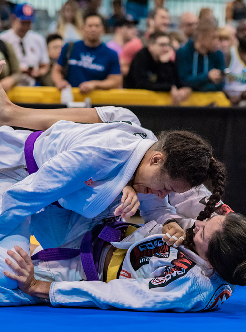 Students at a Women's Self-Defense class practicing Brazilian Jiu-Jitsu