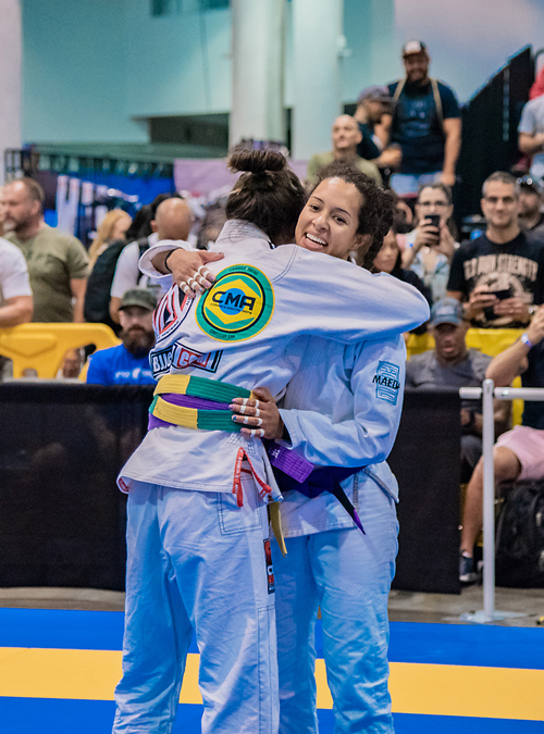 Students at a Women's Self-Defense class show respect to each other